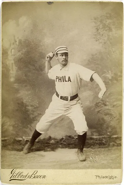 19th-century baseball player from Philadelphia wearing a striped pillbox cap, photographed in the 1880s.