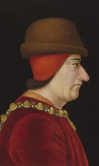 The Complete History of Hats: How Headwear Shaped Fashion and Culture Through the Ages 7 Portrait of King Louis XI of France wearing a brown felt chaperon over a red hood, showing late 15th-century hat fashion.