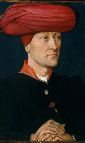 The Complete History of Hats: How Headwear Shaped Fashion and Culture Through the Ages 6 15th-century man wearing a red chaperon hat, showing medieval fashion (The Met Museum).