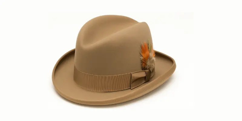 Classic tan Homburg hat with grosgrain ribbon and decorative feather.