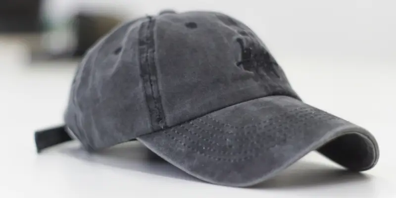 26 Different Types of Hats Explained (With Names, Styles & Pictures) 4 Gray baseball cap placed on a white surface