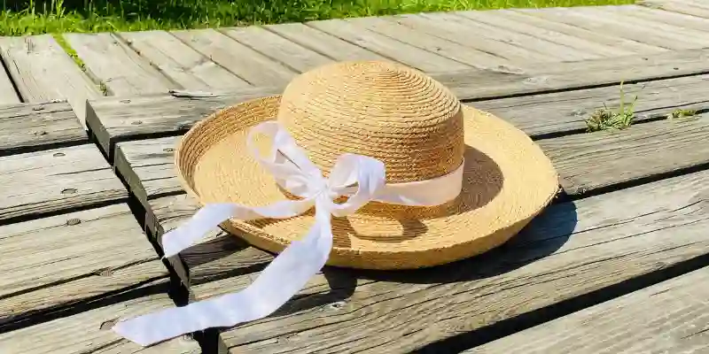 26 Different Types of Hats Explained (With Names, Styles & Pictures) 22 Brown sun hat placed on a brown wooden table in natural light