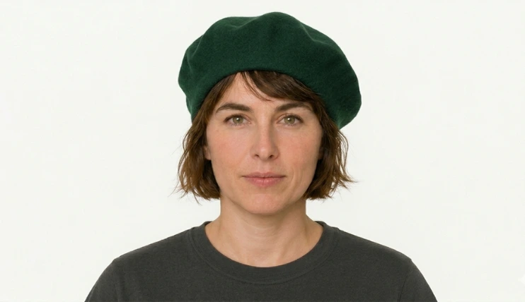 Woman with short hair wearing a beret slightly behind the hairline and tilted to one side