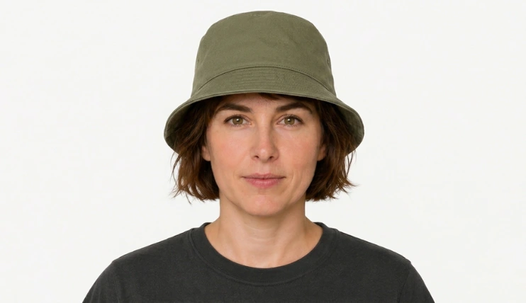 Woman with short hair wearing a bucket hat correctly with the brim sitting above the eyebrows