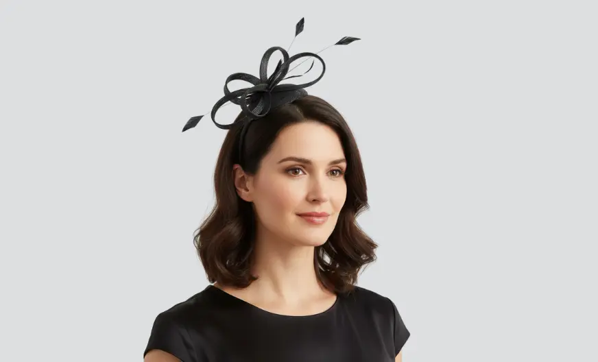 Adult woman wearing a medium-sized stylish fascinator securely for a cocktail party