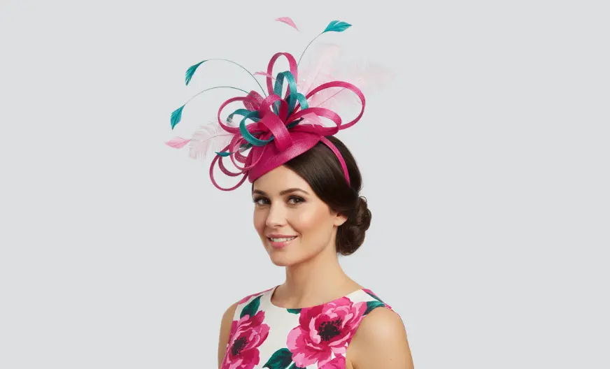 Adult woman wearing a large bold fascinator with bright colors for a race or derby event