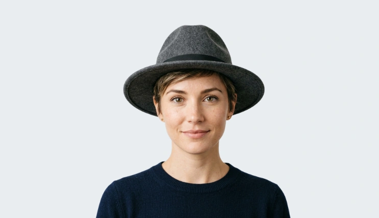 Woman with pixie cut wearing a well-fitted fedora hat with 2.5 inch brim, showing one of the best hats for pixie cut hairstyles