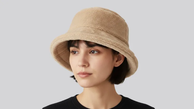 Woman with short hair wearing a faux fur fuzzy bucket hat