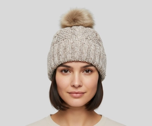 Woman with short hair wearing a winter faux fur pom fleece lined beanie