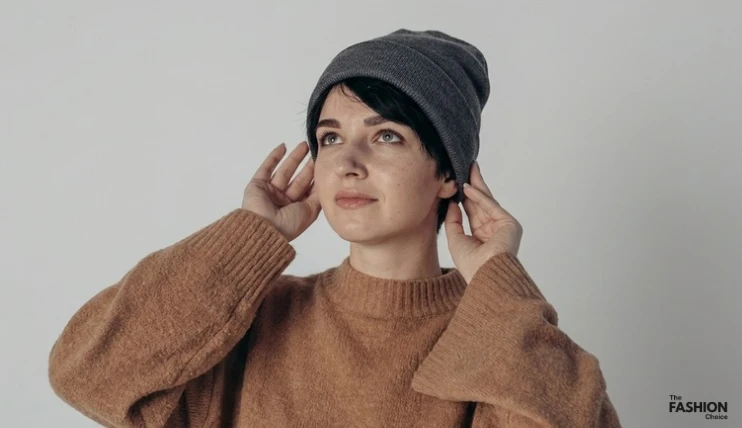 7 Best Winter Hats for Short Hair 10 Woman with short pixie hair wearing a Smartwool-style merino wool beanie
