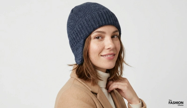 7 Best Winter Hats for Short Hair 15 Woman wearing a dark navy WMCAPS earflap beanie with a ribbed-knit crown and fuzzy earflaps
