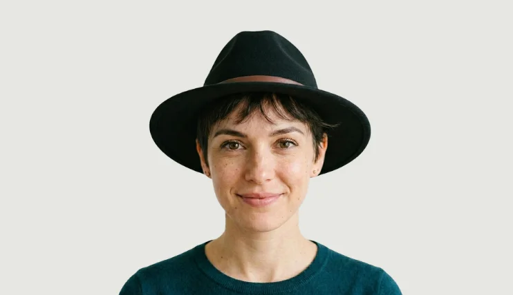 Woman wearing a black fedora hat, perfect for pixie cut hairstyle