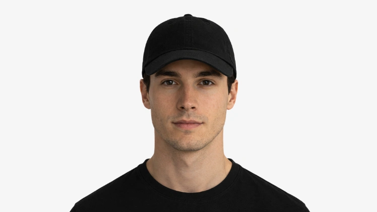 Man with an oval face wearing a black low-profile dad hat showing why it is one of the best hats for oval faces with balanced crown and brim