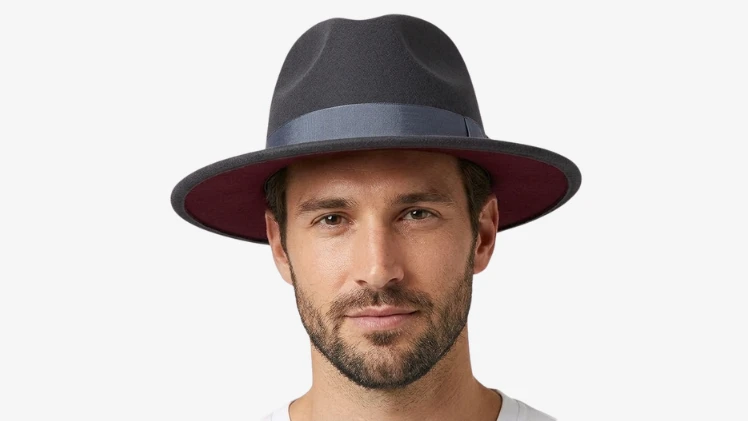 Man with an oval face wearing a wide brim felt fedora, showing why it is one of the best hats for oval faces with balanced crown and brim