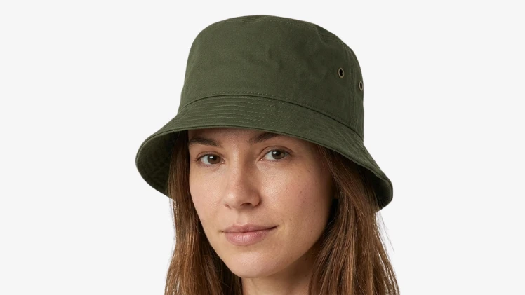 Woman with an oval face wearing a cotton bucket hat, showing why it is one of the best hats for oval faces with balanced proportions