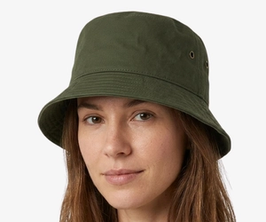 Woman with an oval face wearing a cotton bucket hat, showing why it is one of the best hats for oval faces with balanced proportions