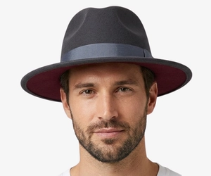 Man with an oval face wearing a wide brim felt fedora, showing why it is one of the best hats for oval faces with balanced crown and brim