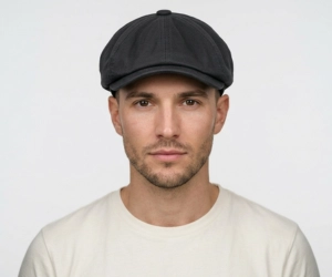 Man with heart shaped face wearing a newsboy cap