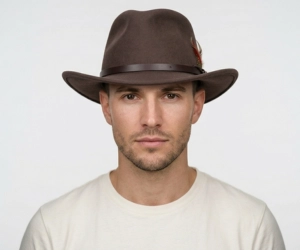 Man with heart shaped face wearing a chocoloate brown outback hat
