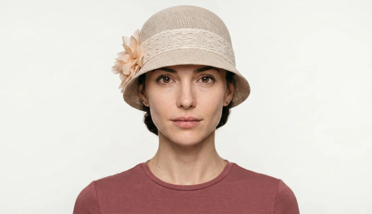 Best Hats for Inverted Triangle Face Shape That Actually Work 14 Woman with inverted triangle face shape wearing a beige cloche hat with lace band and flower detail