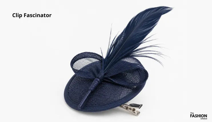 Navy blue clip fascinator with sinamay base, bow, and feather attached to an alligator clip, showing the clip fascinator type