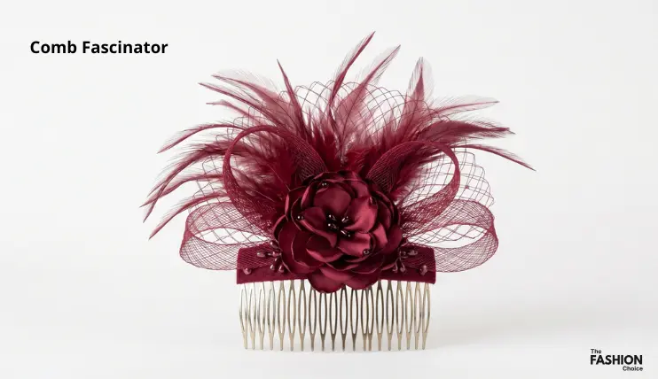 Burgundy comb fascinator with satin flower, netting, and feathers attached to a silver hair comb, showing the comb fascinator type