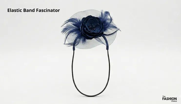Navy blue elastic band fascinator with satin flower, tulle netting, and feathers attached to a thin black elastic band, showing the elastic band fascinator type