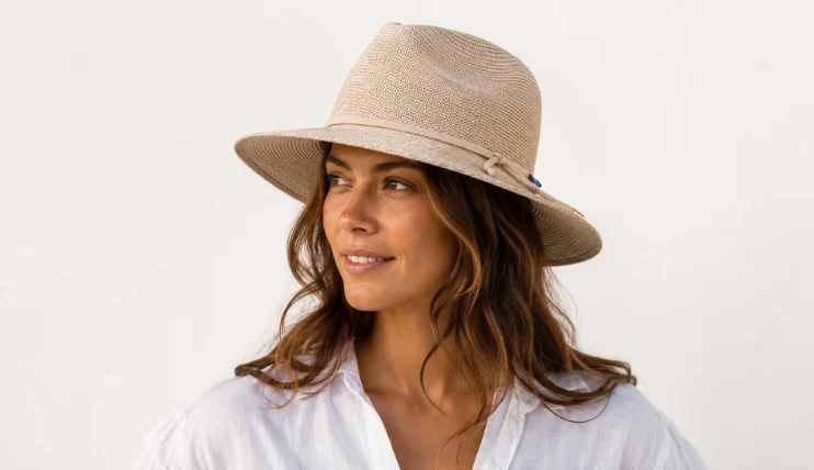 Best UPF Hats for Women (2026) 15 Woman wearing Wallaroo Victoria Fedora with wide brim and decorative band for UPF 50+ sun protection