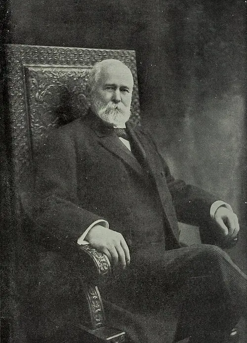 John B. Stetson seated in a chair, circa 1906