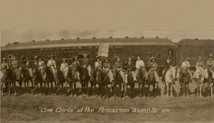 Historical 1911 panoramic photograph by M.B. Marcell showing a large group of cowgirls on horses at the Pendleton Round-Up in Oregon.