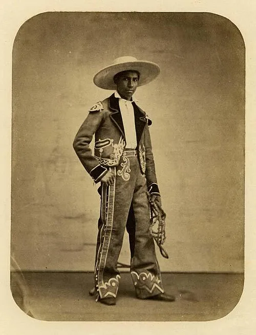 Historical photograph of an early Texas cowboy wearing a traditional Spanish sombrero with a flat crown and wide flat brim.