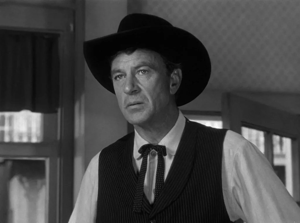 Actor Gary Cooper wearing a wide-brimmed cowboy hat as Marshal Will Kane in High Noon.