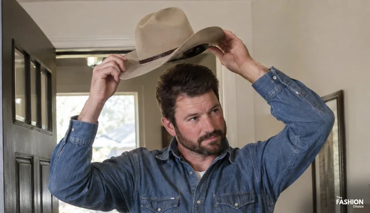 Cowboy removing his hat by the brim when entering a home